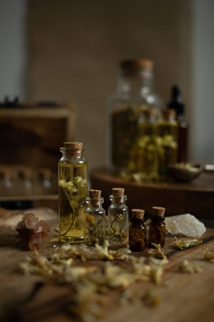 pexels-photo-20419194 A collection of rustic glass bottles with aromatic herbs on a wooden table, perfect for aromatherapy themes.