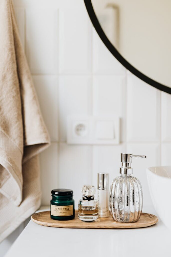 pexels-photo-4239014 Composition of liquid soap perfume and skincare products placed on bamboo plate in modern bathroom